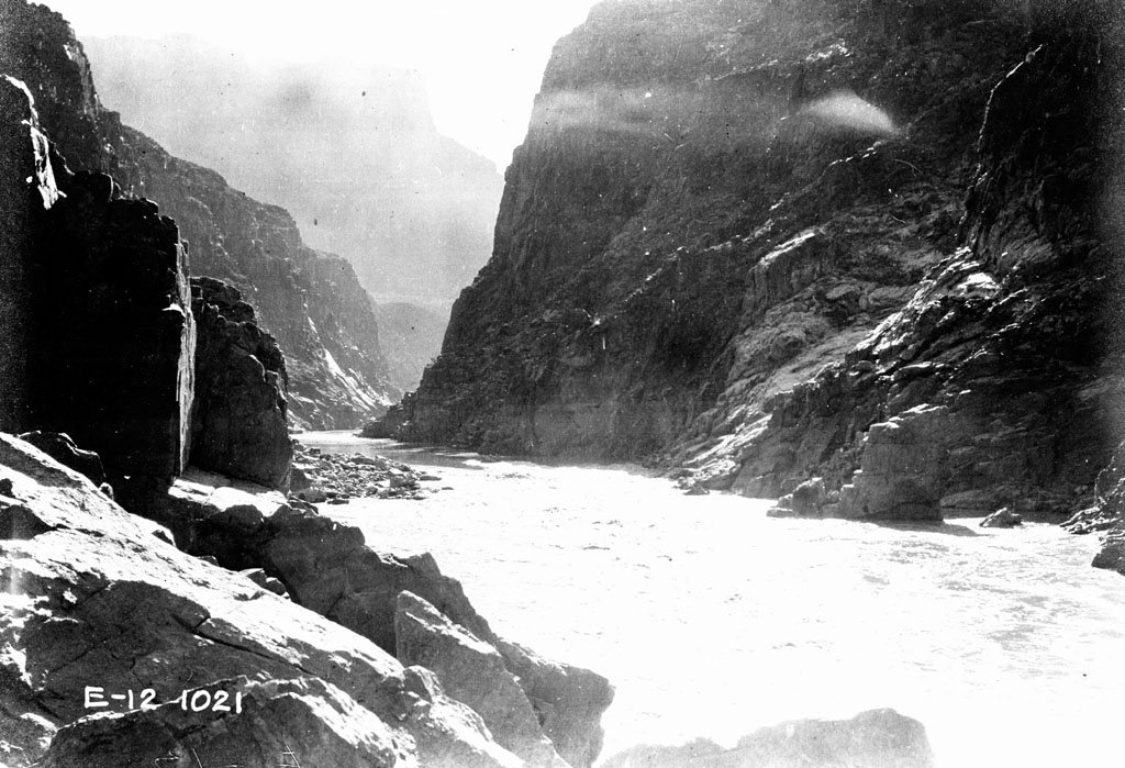 Colorado River canyon walls and search boats